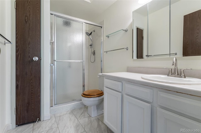 bathroom featuring a shower with door, toilet, and vanity