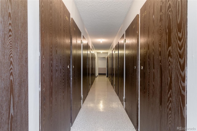 hall with a textured ceiling