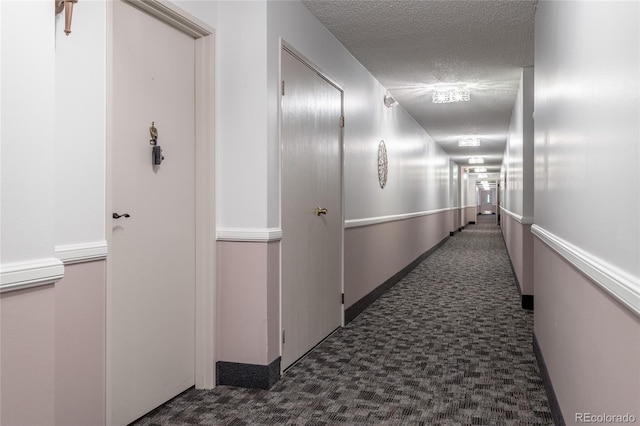 hallway with a textured ceiling