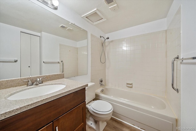 full bathroom with toilet, washtub / shower combination, vanity, and wood finished floors