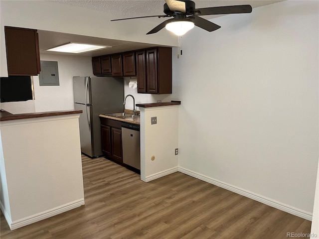 8555 Fairmount Dr Unit A108, Denver, CO 80247 - kitchen with stainless steel appliances, a sink, electric panel, dark brown cabinetry, and light wood-style floors