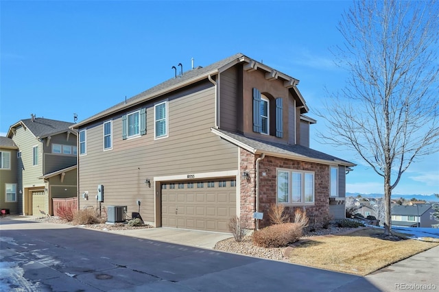 view of property exterior featuring cooling unit and a garage