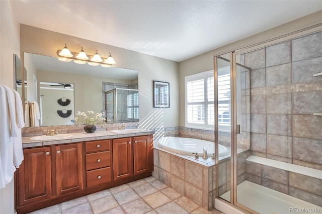 bathroom with shower with separate bathtub, vanity, and tile patterned floors