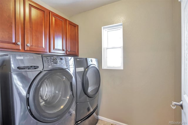 laundry area featuring cabinets and separate washer and dryer