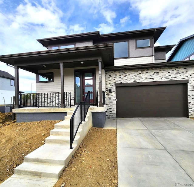 view of front of house featuring a garage and covered porch