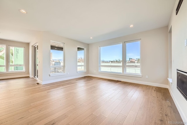 unfurnished living room with light wood-type flooring