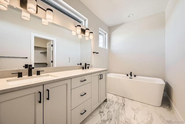 bathroom featuring vanity and a bath