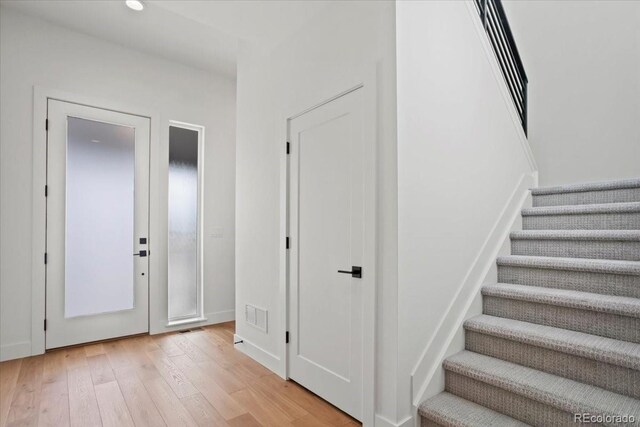 5604 Grandville Ave, Longmont, CO 80503 - foyer with stairway, recessed lighting, light wood finished floors, and visible vents