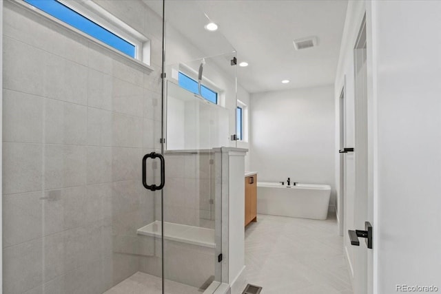 5604 Grandville Ave, Longmont, CO 80503 - full bath with a freestanding tub, vanity, recessed lighting, a shower stall, and visible vents