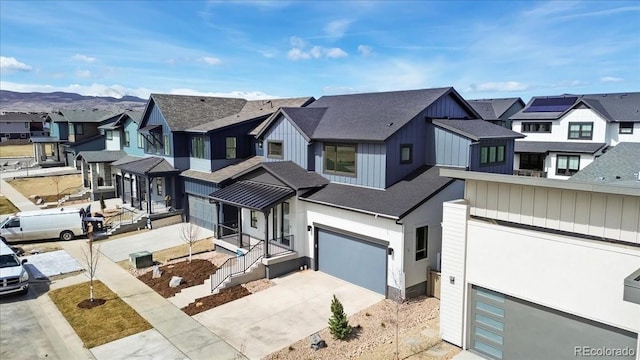 5604 Grandville Ave, Longmont, CO 80503 - view of front facade featuring an attached garage, board and batten siding, concrete driveway, and a residential view