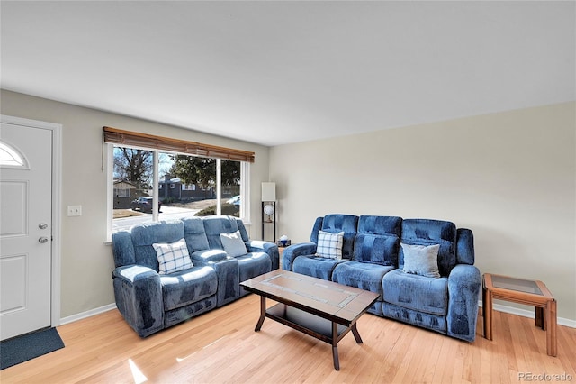 living area with light wood-style flooring and baseboards