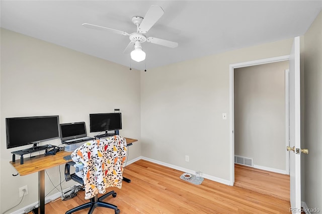 office with ceiling fan, wood finished floors, visible vents, and baseboards