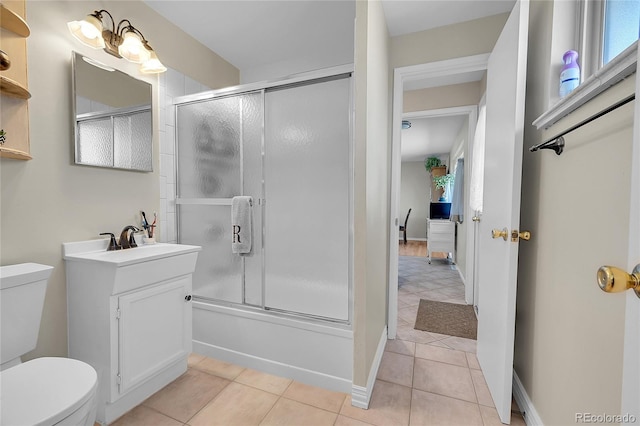 full bath with toilet, shower / bath combination with glass door, and tile patterned flooring