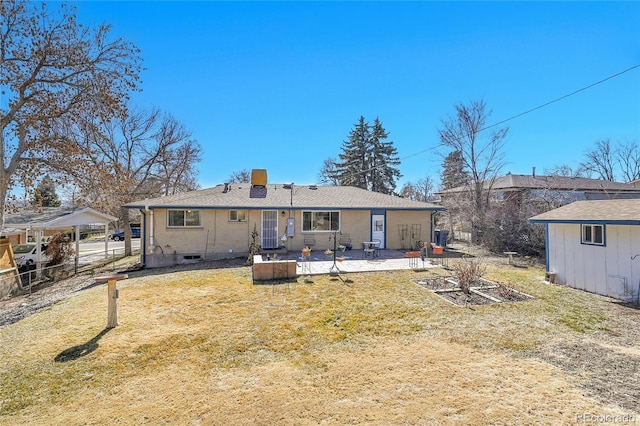 rear view of house featuring a patio area, a chimney, fence, and a lawn