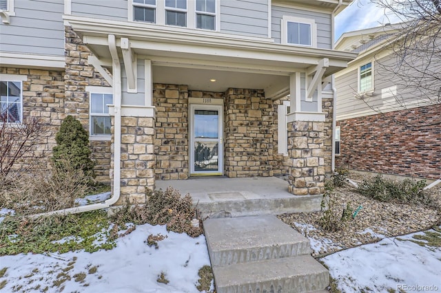 view of snow covered property entrance