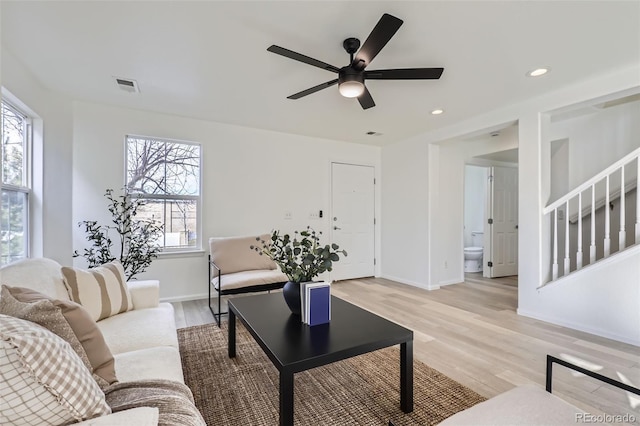 living room with ceiling fan and light wood-type flooring