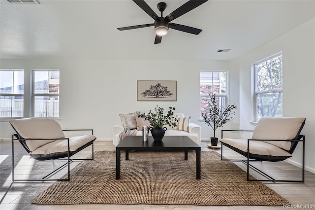 sitting room featuring ceiling fan and hardwood / wood-style floors