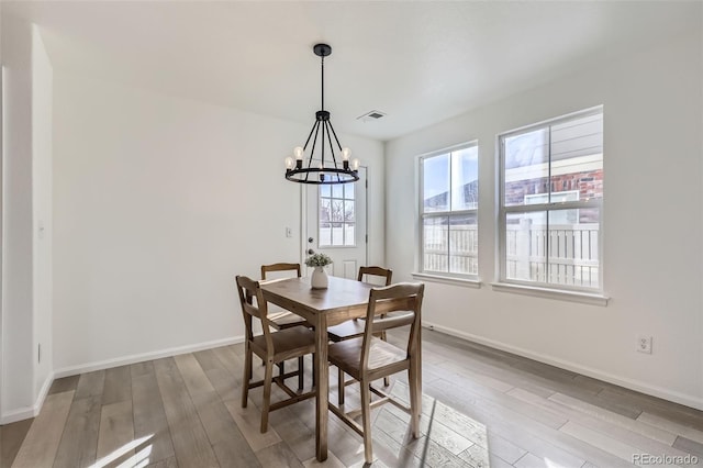 dining space featuring a chandelier and hardwood / wood-style flooring