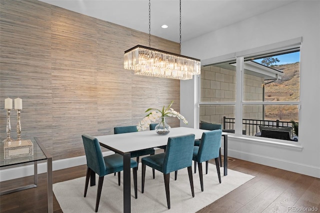 dining room featuring dark hardwood / wood-style flooring and a chandelier