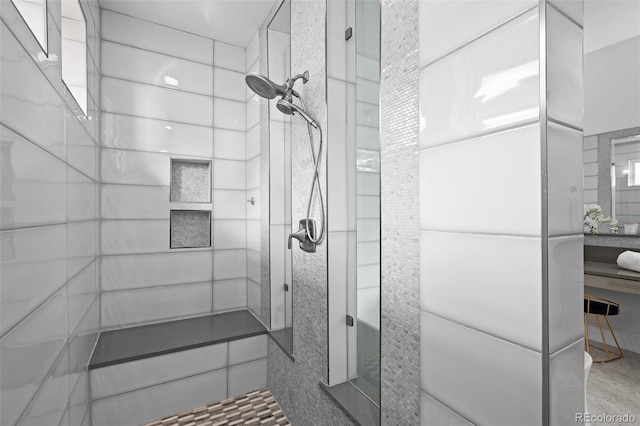 bathroom with a tile shower