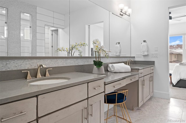 bathroom with tasteful backsplash, ceiling fan, and vanity