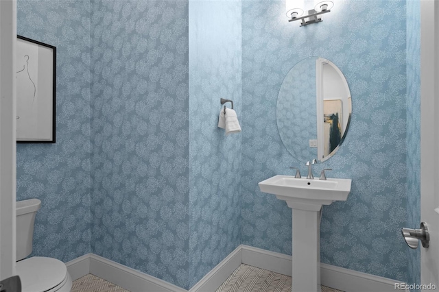 bathroom featuring tile patterned flooring, sink, and toilet