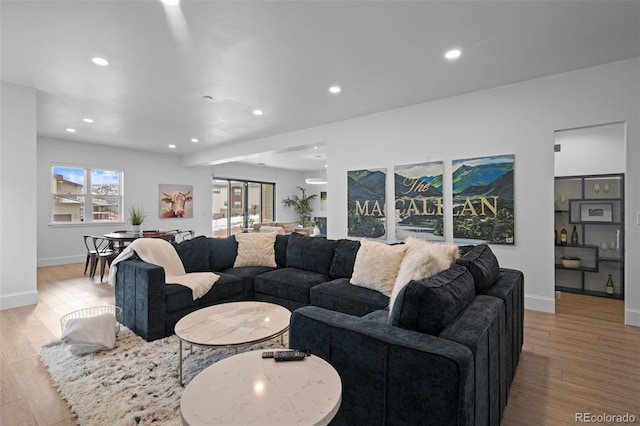 living room featuring a wealth of natural light and light hardwood / wood-style floors