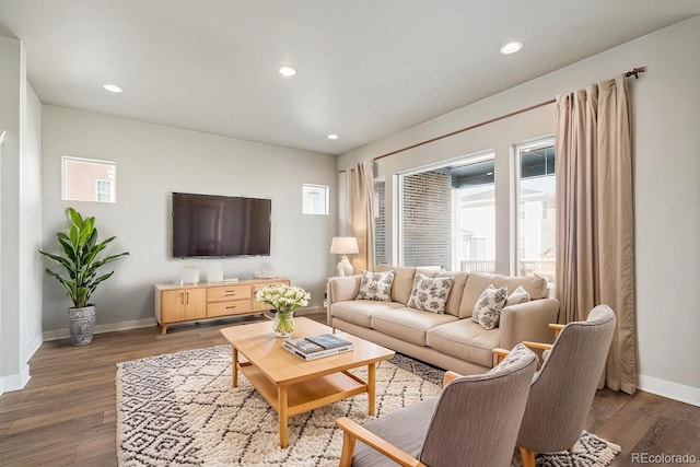 living area featuring recessed lighting, wood finished floors, and baseboards