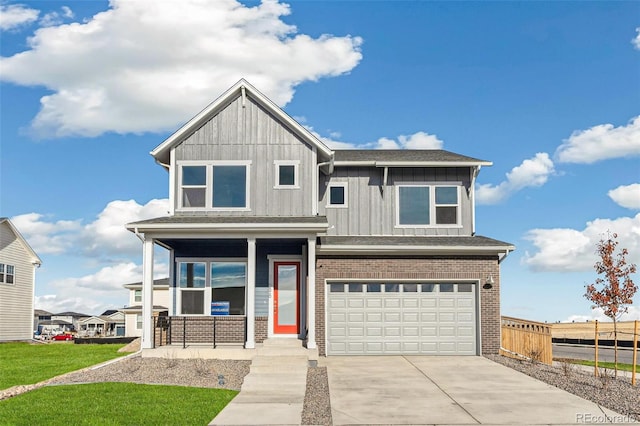 21295 E 61st Dr, Aurora, CO 80019 - view of front of house with concrete driveway, an attached garage, board and batten siding, covered porch, and brick siding