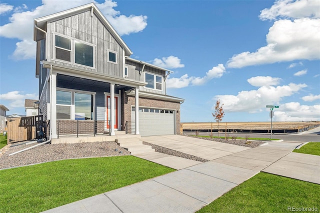 21295 E 61st Dr, Aurora, CO 80019 - view of front of home featuring concrete driveway, an attached garage, board and batten siding, a porch, and brick siding