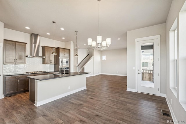 21295 E 61st Dr, Aurora, CO 80019 - kitchen with wall chimney range hood, tasteful backsplash, a sink, stainless steel appliances, and visible vents