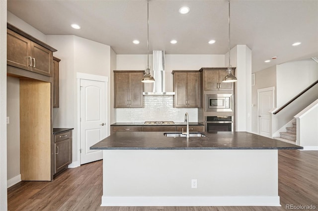 21295 E 61st Dr, Aurora, CO 80019 - kitchen featuring wall chimney exhaust hood, stainless steel appliances, a sink, backsplash, and dark wood-type flooring