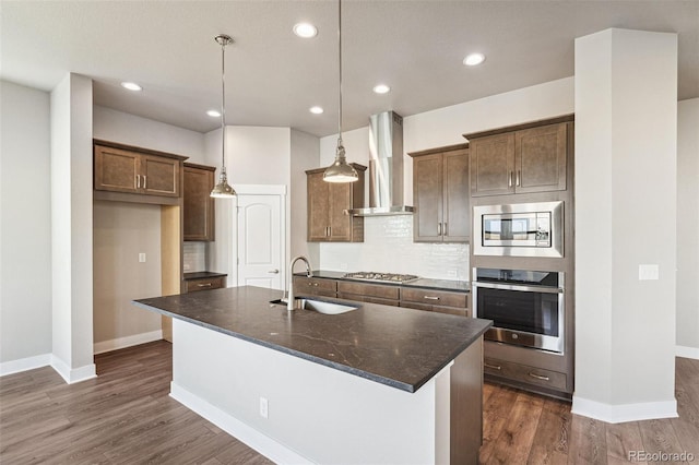 21295 E 61st Dr, Aurora, CO 80019 - kitchen featuring baseboards, wall chimney exhaust hood, stainless steel appliances, and a sink