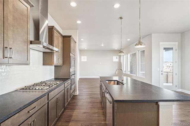 21295 E 61st Dr, Aurora, CO 80019 - kitchen featuring recessed lighting, dark wood-style floors, a sink, wall chimney exhaust hood, and appliances with stainless steel finishes