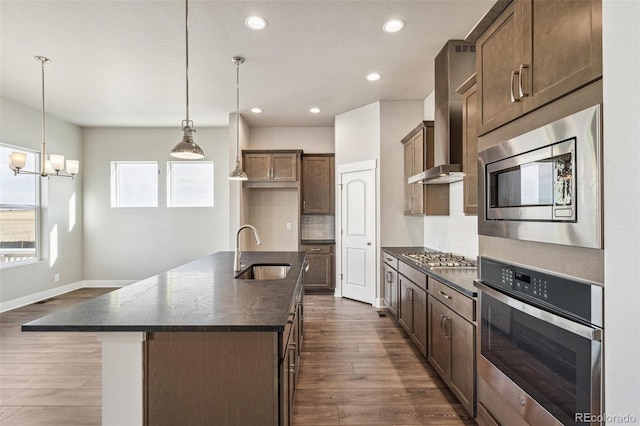 21295 E 61st Dr, Aurora, CO 80019 - kitchen with stainless steel appliances, a sink, recessed lighting, and dark wood finished floors