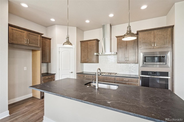 21295 E 61st Dr, Aurora, CO 80019 - kitchen featuring wall chimney range hood, a sink, dark wood-type flooring, baseboards, and appliances with stainless steel finishes