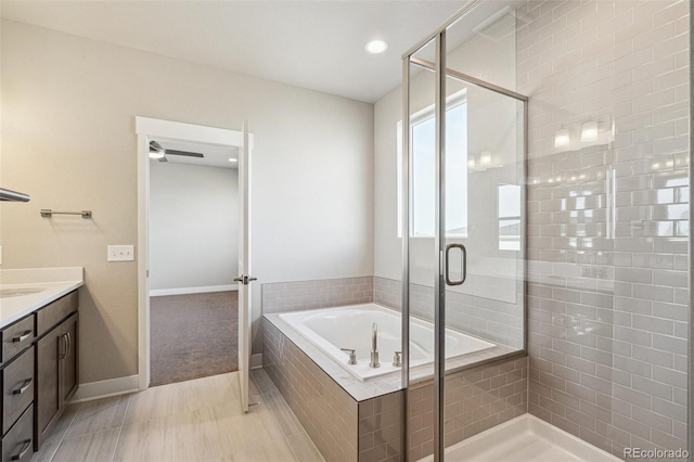 21295 E 61st Dr, Aurora, CO 80019 - full bath featuring a bath, baseboards, vanity, and a stall shower