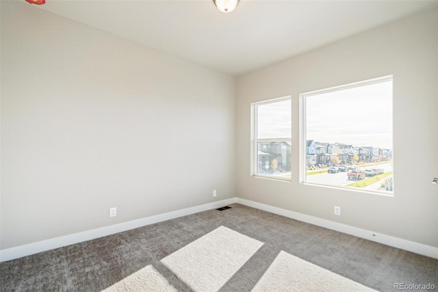 21295 E 61st Dr, Aurora, CO 80019 - carpeted spare room featuring visible vents and baseboards