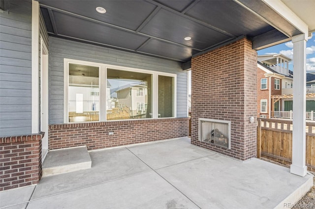 21295 E 61st Dr, Aurora, CO 80019 - view of patio / terrace featuring fence and an outdoor brick fireplace