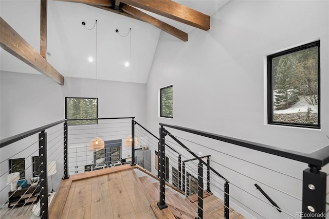 379 Rainbow Rd, Idaho Springs, CO 80452 - corridor with an upstairs landing, high vaulted ceiling, beam ceiling, and wood finished floors