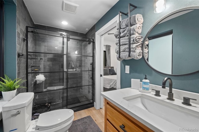 379 Rainbow Rd, Idaho Springs, CO 80452 - ensuite bathroom featuring toilet, a stall shower, wood finished floors, and vanity
