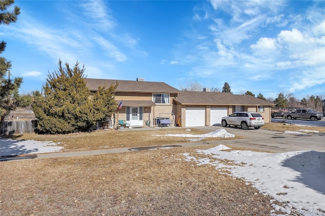 10559 W 58th Ave, Arvada, CO 80002 - tri-level home with an attached garage and driveway