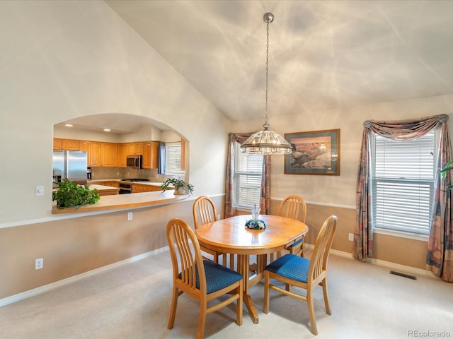 7158 W Belmont Dr, Littleton, CO 80123 - dining area featuring visible vents, light carpet, a wealth of natural light, and an inviting chandelier