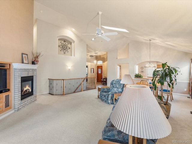 7158 W Belmont Dr, Littleton, CO 80123 - carpeted living room with a brick fireplace, high vaulted ceiling, and ceiling fan with notable chandelier