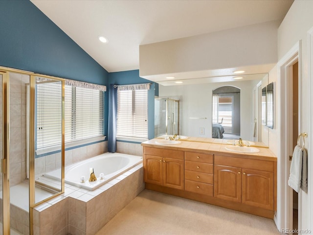 7158 W Belmont Dr, Littleton, CO 80123 - full bathroom featuring vaulted ceiling, a sink, a bath, and a stall shower