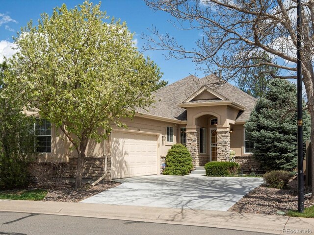 7158 W Belmont Dr, Littleton, CO 80123 - single story home with an attached garage, stucco siding, stone siding, and concrete driveway