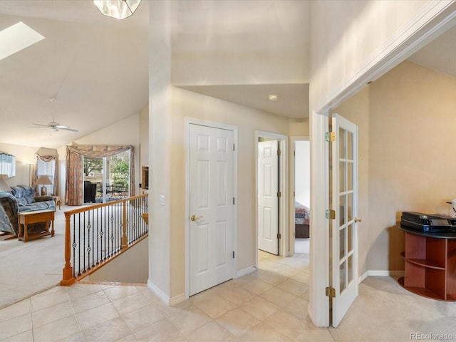 7158 W Belmont Dr, Littleton, CO 80123 - carpeted entryway featuring french doors, a skylight, tile patterned flooring, high vaulted ceiling, and baseboards