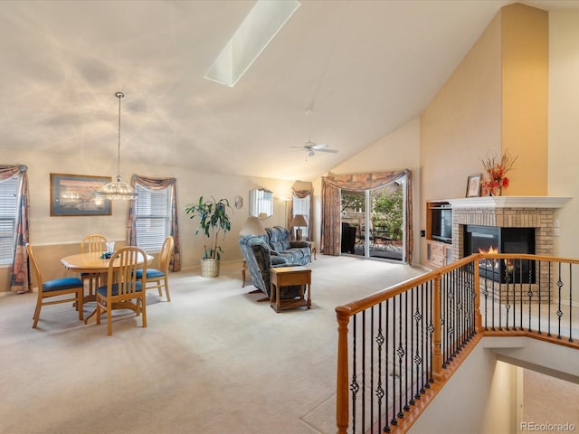 7158 W Belmont Dr, Littleton, CO 80123 - carpeted living area with baseboards, vaulted ceiling, ceiling fan with notable chandelier, and a fireplace