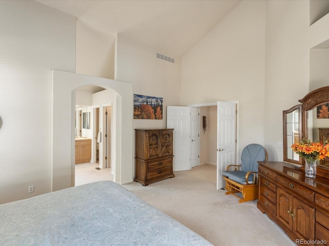 7158 W Belmont Dr, Littleton, CO 80123 - bedroom with arched walkways, high vaulted ceiling, light colored carpet, and visible vents