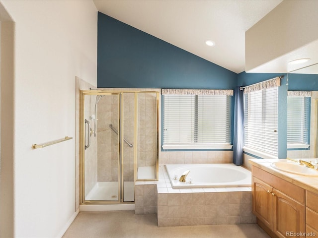 7158 W Belmont Dr, Littleton, CO 80123 - full bath featuring vanity, vaulted ceiling, a stall shower, and a garden tub